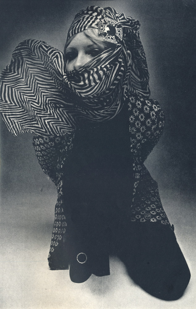 Trouser suit and black lurex roll neck sweater designed by Sonia Rykiel. Both from The Shop, Vidal Sassoon, Sloane Street. Scarf from Suna's Shop, 47 Radnor Walk.