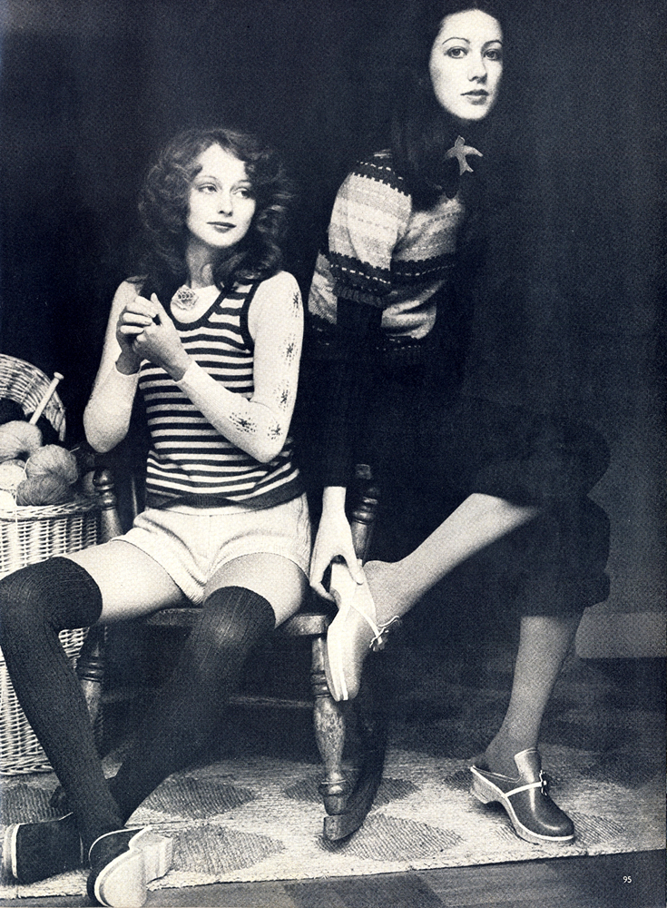 Vest and pullover both by Alice Pollock at Quorum. Pink knitted shorts by Alistair Cowin at Grade One. All clogs from Mayfair Market. Puff sleeved sweater in stripes of tuqouoise, pink and navy, acrylic tibbed dark blue polo neck undeneath, dark blue knitted trousers rolled up. All by John Craig at Stop the Shop. 