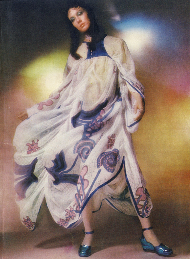 Printed silk chiffon looped into a skirt, gathered from a tiny blue satin bodice, with blue satin ribbon at hem. By Zandra Rhodes, £89, at Fortnum & Mason. Tiered metallic platform shoes, 9gns, at Rowley & Oram of Kensintyon Market. Beaded choker, by Bibette, from range at Thea Porter. Rings from Hope and Eleanor, Chelsea Antique Market.