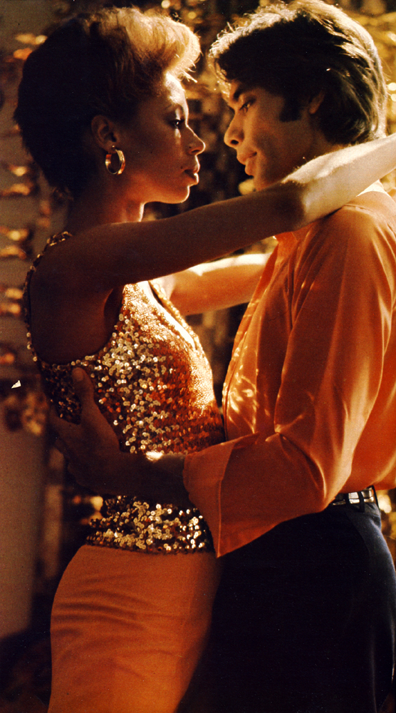 Turn him on. This winter's most glamorous party vest has that 1000 watt gleam. Larrio, the six foot four dancer at the London Contemporary Dance Theatre, is electrified by Jan. "Give me lots of pretty girls, lock the door and let me get at them! I really dig dancing the night away. If I give a party I like it to go on for nights and days." Jan's high-voltage sequin vest is from Biba,£11.45 ; pants, £10, from Gordon King. Earrings from Adrien Mann. Larrio's silk shirt from a selection at Browns.  