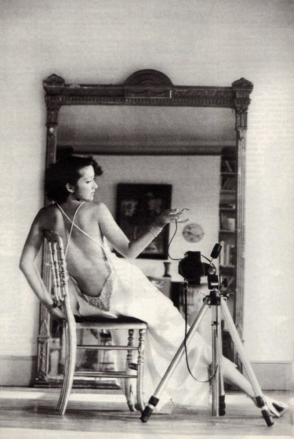 White satin nightdress by Janet Reger. White silk stockings from Wardrobe. Gold leather shoes from Russell and Bromley.