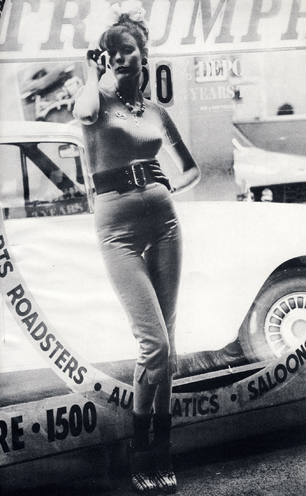Short sleeved pale lilac sweater by Beckol from Chelsea Girl. Silvery-grey cotton pedal pushers by Antony Price from Che Guevera. Red, white and blue tartan shoes from Zapata. Wide red elasticated belt by Otto Glantz.