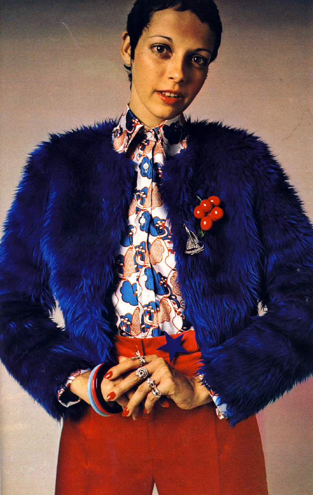 Boxy Borg jacket with scarlet satin lining and satin trousers both by Sujon. Bubble printed silk shirt by Jasper. Cherries and other jewellery by Adrien Mann.