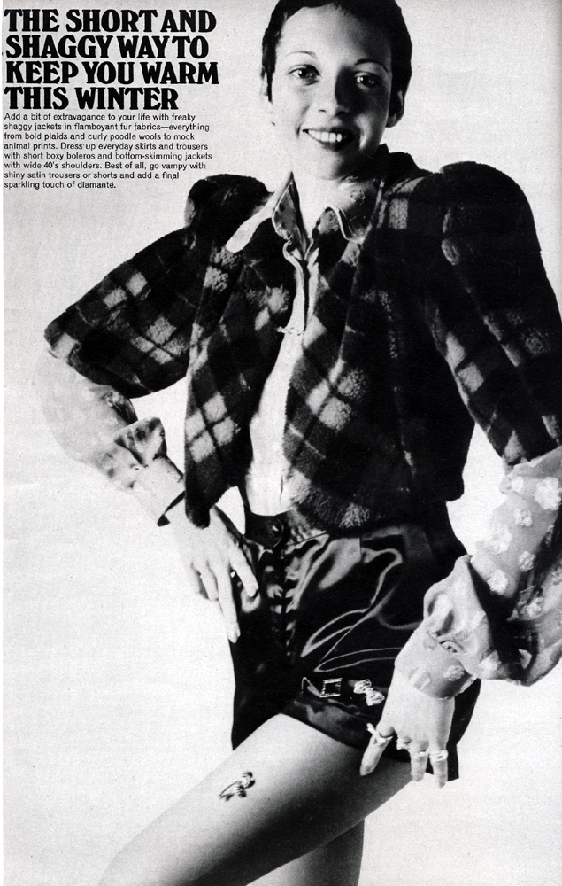 Scarlet and navy Courtelle plaid bolero jacket and black satin shorts both from Martha Hill. Cherry red and multi coloured cotton voile shirt by Jasper from Stop the Shop. Sheer tights by Sunarama. All jewellery by Bus Stop.